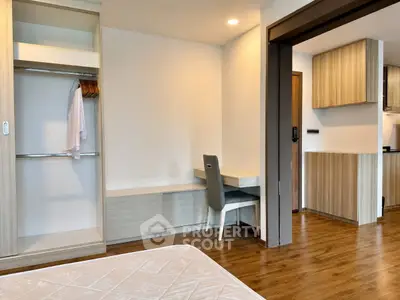 Modern bedroom with open closet and study area in stylish apartment