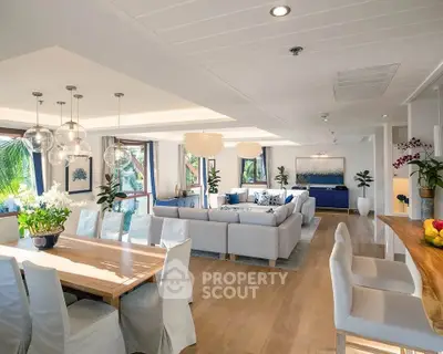 Luxurious open-plan living and dining area with modern decor and abundant natural light.