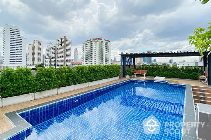 Stunning rooftop pool with city skyline view, perfect for relaxation and entertainment.