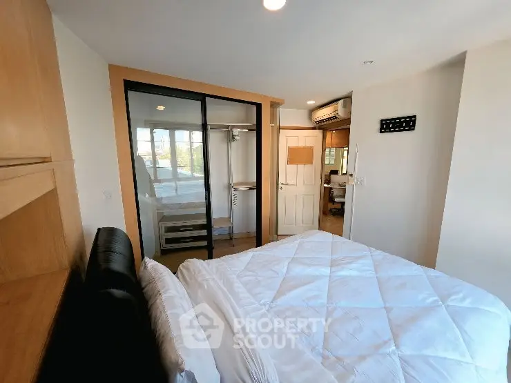 Cozy bedroom with modern closet and natural light