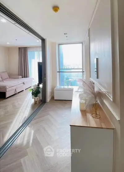 Spacious modern living room with elegant decor and large windows offering abundant natural light.