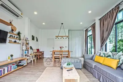 Spacious modern living room with large windows and stylish decor