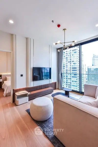 Modern living room with city view, stylish furniture, and elegant lighting in a high-rise apartment.