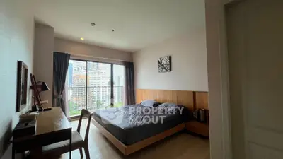Modern bedroom with city view, featuring a cozy bed and stylish wooden furniture, perfect for urban living.