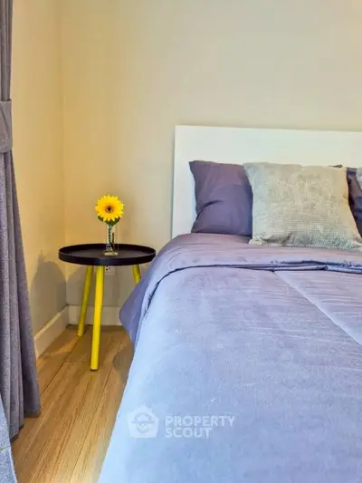 Cozy bedroom with stylish decor and vibrant accents, perfect for relaxation and comfort.