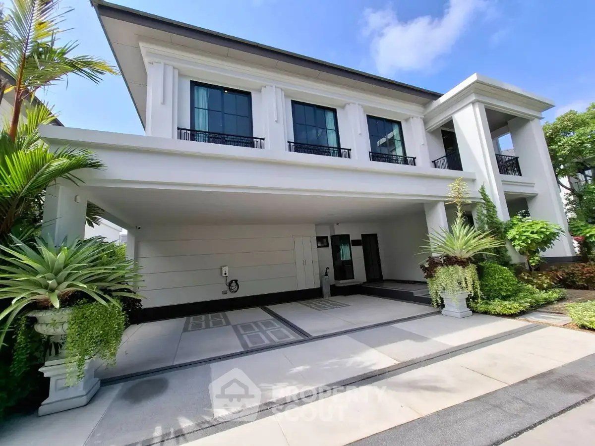 Luxurious modern house with spacious driveway and lush greenery