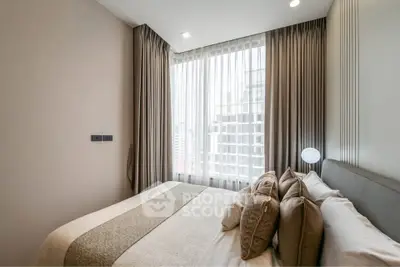 Luxurious bedroom with elegant decor and city view through large windows.