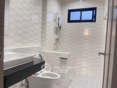 Modern bathroom with sleek white tiles and contemporary fixtures