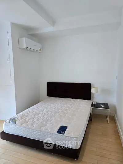 Spacious bedroom with modern air conditioning and minimalist decor