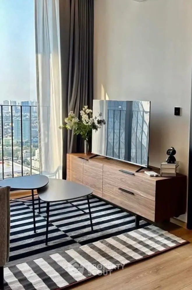 Modern living room with city view, stylish furniture, and large windows.