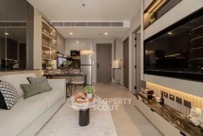Modern living room with open kitchen, stylish decor, and cozy ambiance