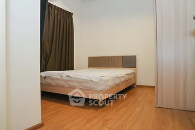 Cozy bedroom with wooden flooring and modern bed frame