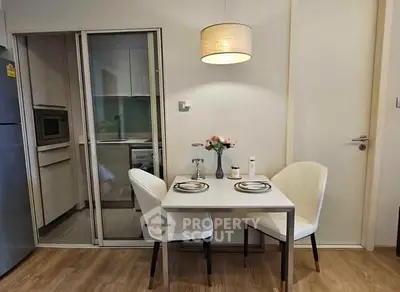 Cozy dining area with modern furniture and elegant lighting in a stylish apartment.