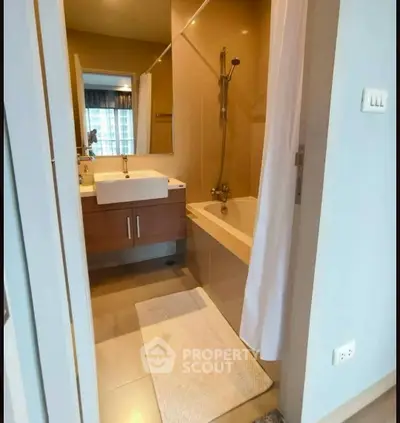 Modern bathroom with sleek fixtures and bathtub in a stylish apartment.