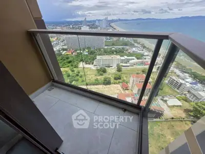 Stunning high-rise balcony with breathtaking ocean and city views, perfect for relaxation and enjoying sunsets.