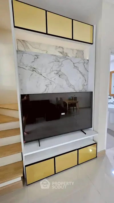 Modern living room with stylish TV unit and marble accent wall