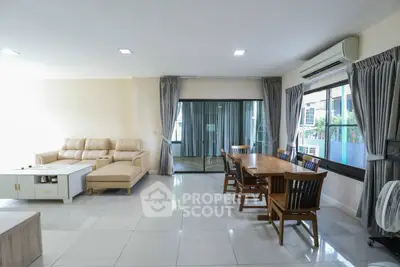 Spacious living room with modern furniture and large windows for natural light