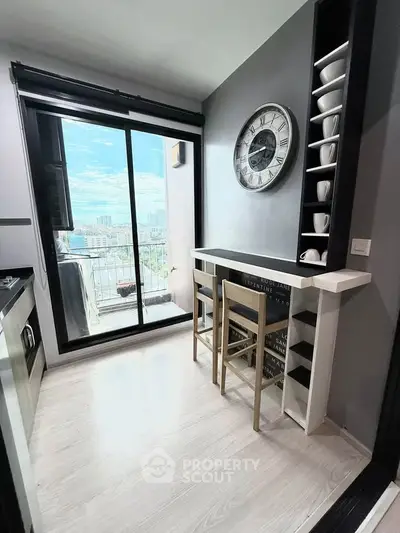 Modern kitchen with open layout and balcony view in urban apartment