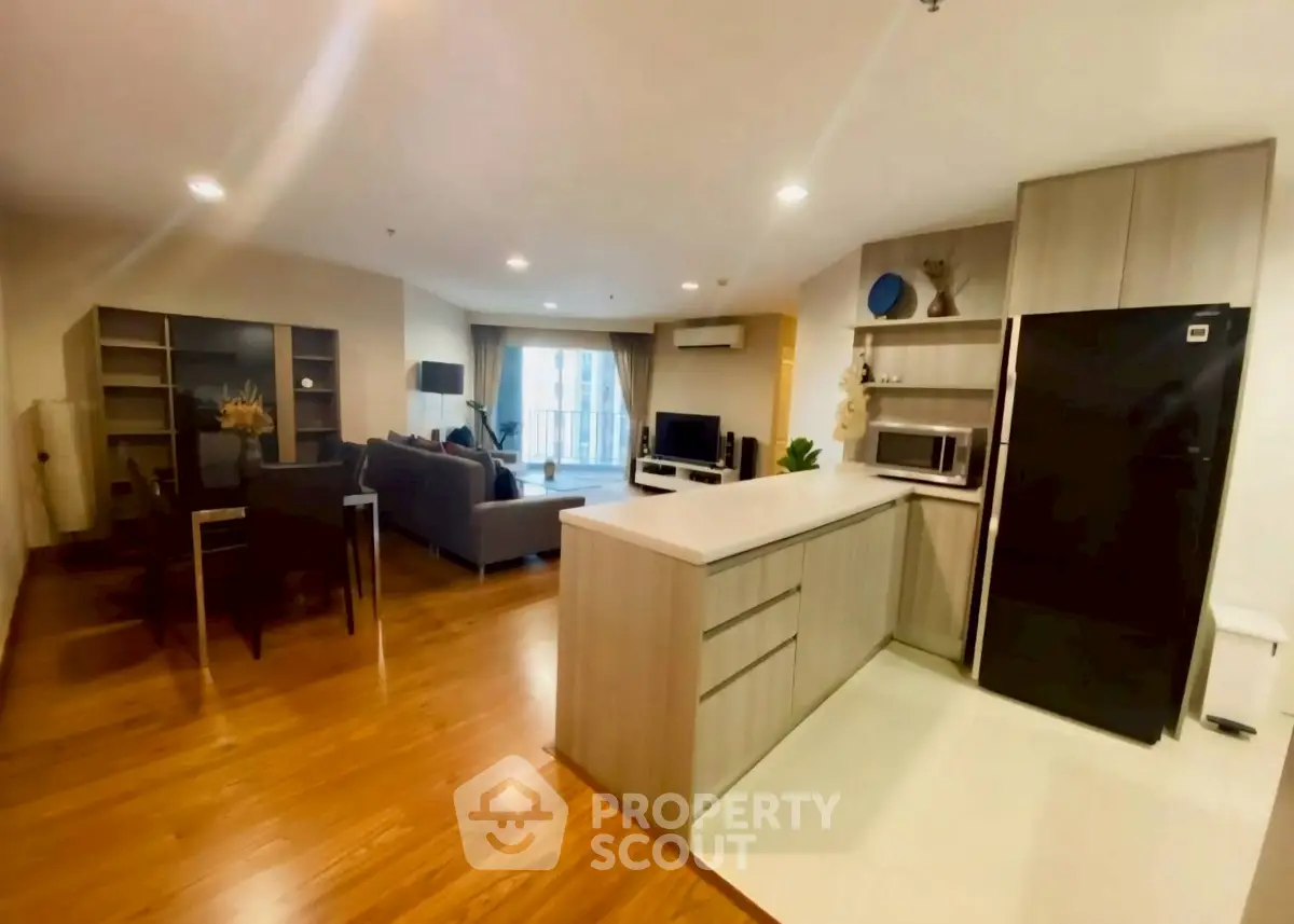 Spacious open-plan kitchen and living room with modern appliances and stylish decor.