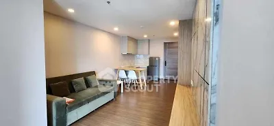 Modern living room with stylish furniture and open kitchen layout in a cozy apartment.