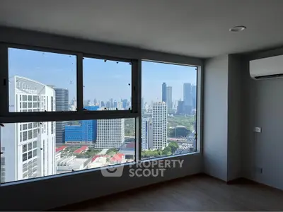 Spacious corner unit with stunning city skyline view from large windows, perfect for urban living.