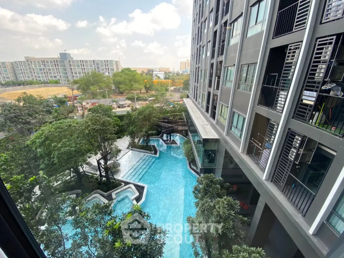 Modern condominium with stunning pool view and lush greenery, perfect for urban living.