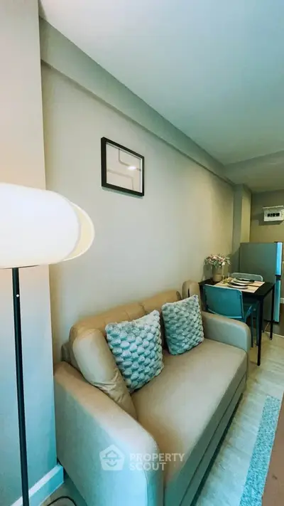 Modern living room with cozy sofa and stylish decor in a contemporary apartment.
