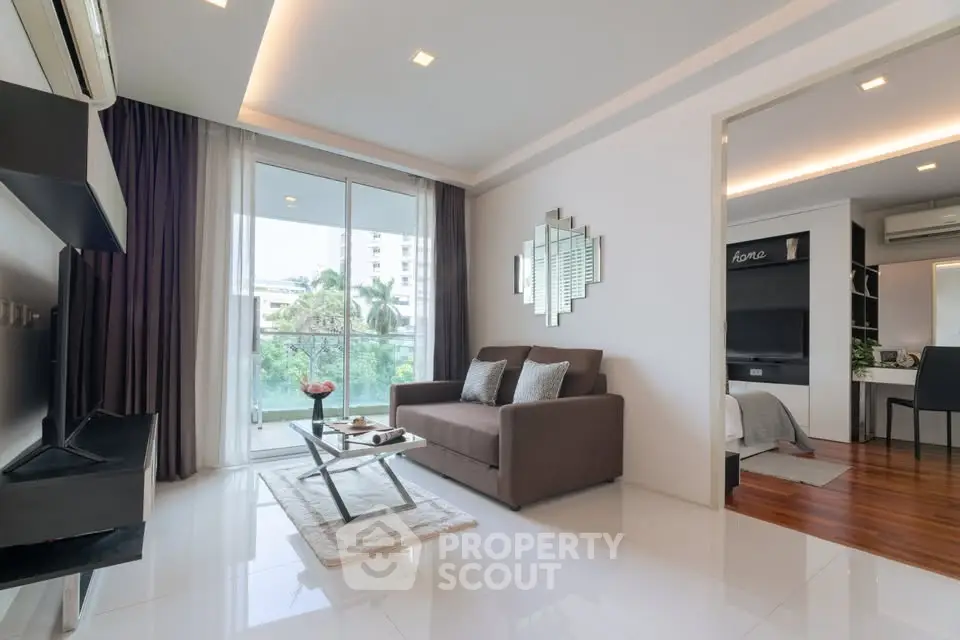 Modern living room with sleek design and balcony view in a stylish apartment.