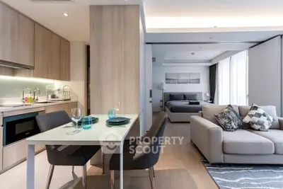 Modern open-plan living room and kitchen with stylish decor and natural light.