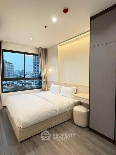 Modern bedroom with city view and elegant furnishings