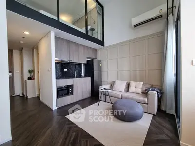 Modern loft-style living room with mezzanine and sleek kitchen design
