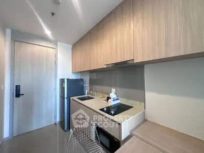Modern kitchen with sleek cabinetry and built-in appliances in a stylish apartment.