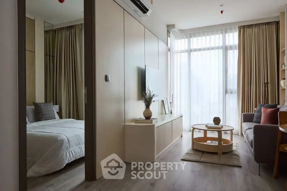 Modern apartment interior with cozy living room and elegant bedroom, featuring floor-to-ceiling windows and stylish decor.