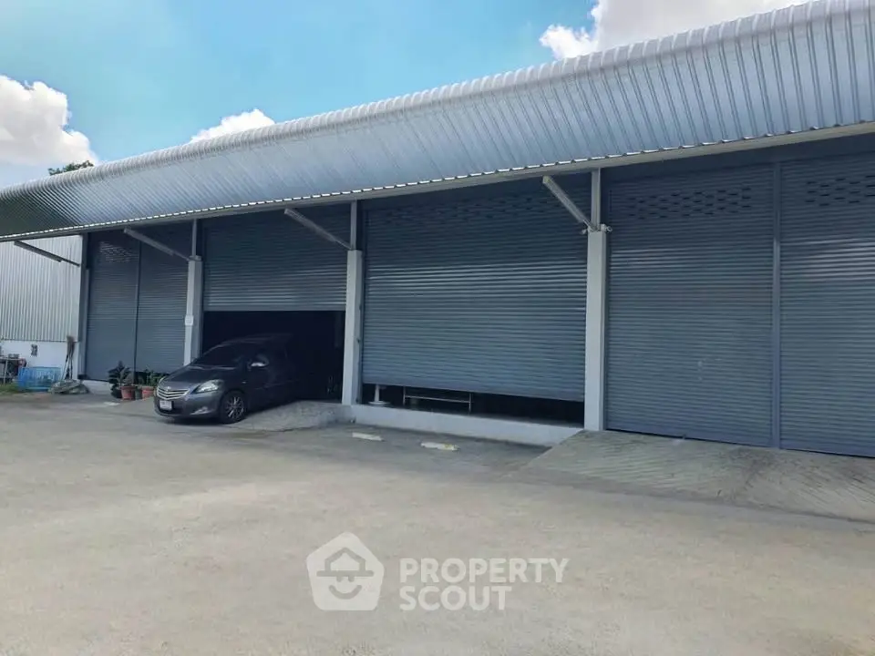 Spacious industrial warehouse with multiple loading bays and ample parking space.