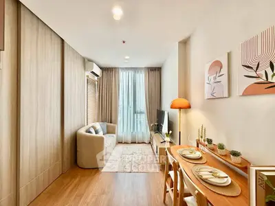 Modern living room with cozy decor and natural light, featuring a stylish sofa and dining area.