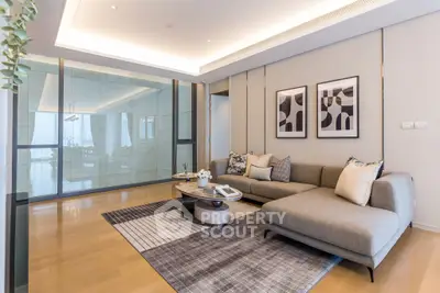 Modern living room with stylish decor and spacious layout, featuring a cozy sectional sofa and elegant artwork.