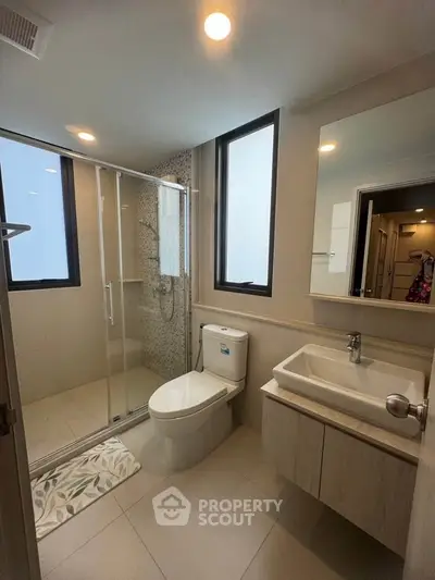 Modern bathroom with sleek fixtures and large shower area