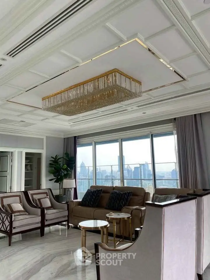 Luxurious living room with stunning city view, elegant chandelier, and modern furnishings.