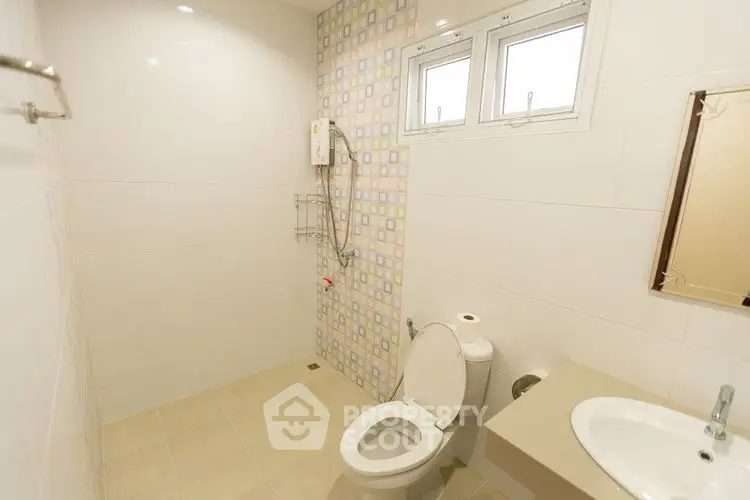 Modern bathroom with tiled walls and compact layout