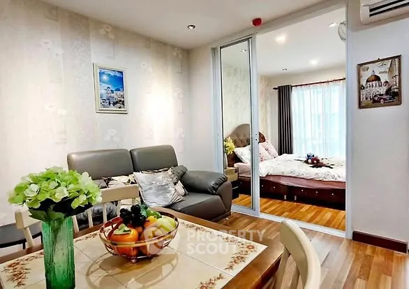 Charming open-plan living room with cozy bedroom view, perfect for modern living.