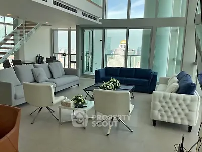 Luxurious modern living room with panoramic city views and elegant furnishings.