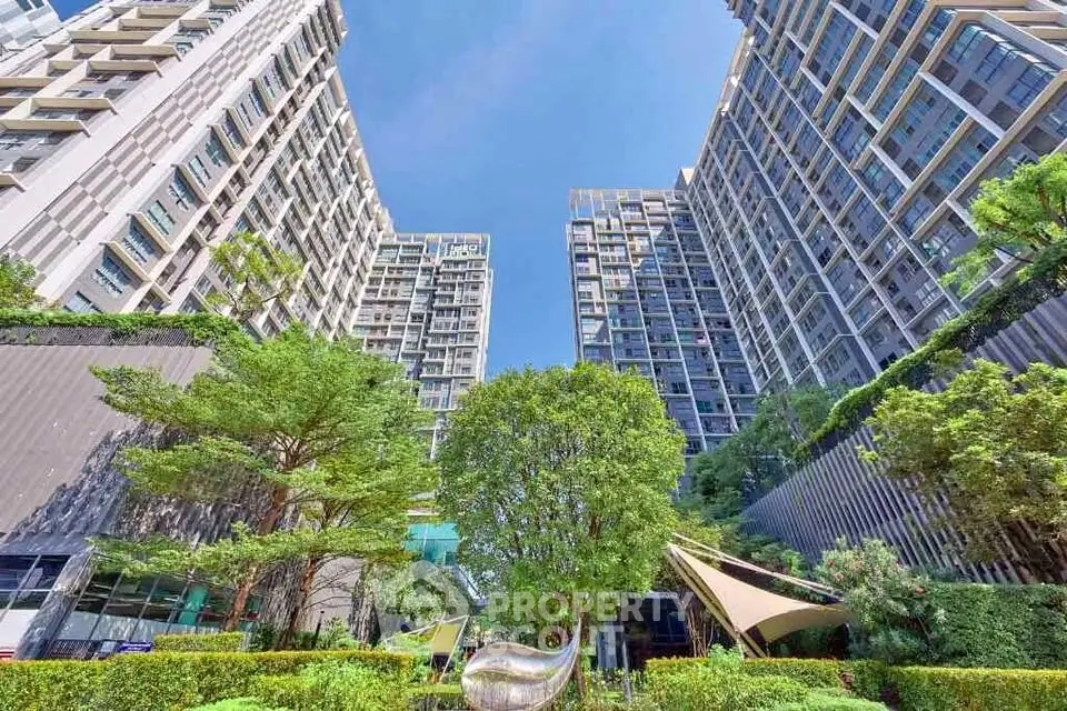 Stunning modern apartment complex with lush greenery and striking architecture.