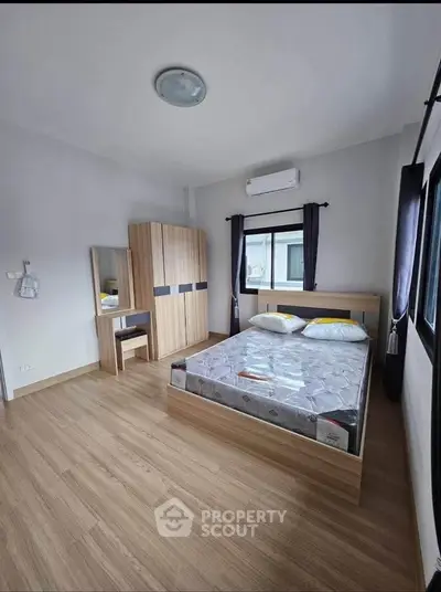 Spacious bedroom with modern furniture and natural light