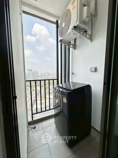 High-rise apartment balcony with washing machine and city view