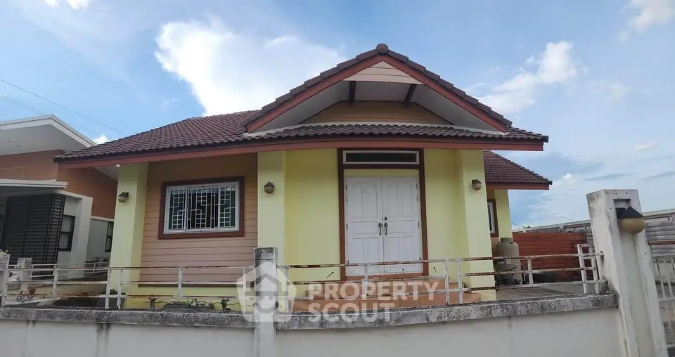 Charming single-story house with a red-tiled roof and inviting front entrance, perfect for family living.