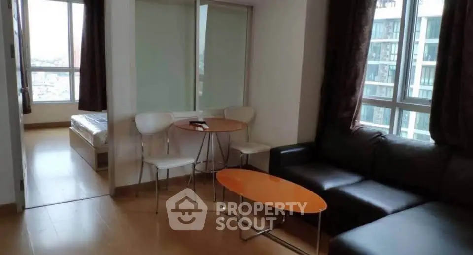 Modern apartment living room with cozy seating and natural light