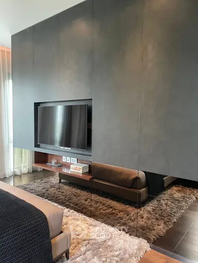 Luxurious bedroom with modern TV setup and plush carpet