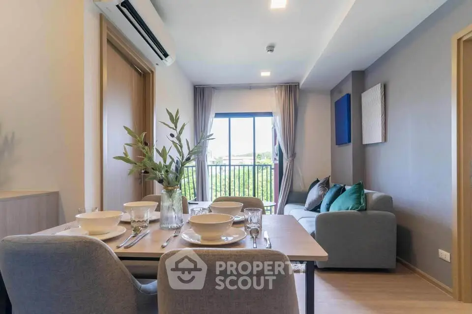 Modern living room with dining area, cozy sofa, and balcony view.