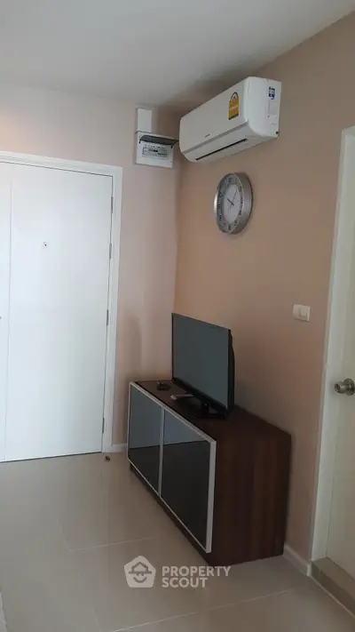 Modern living room with sleek TV stand and wall-mounted air conditioner