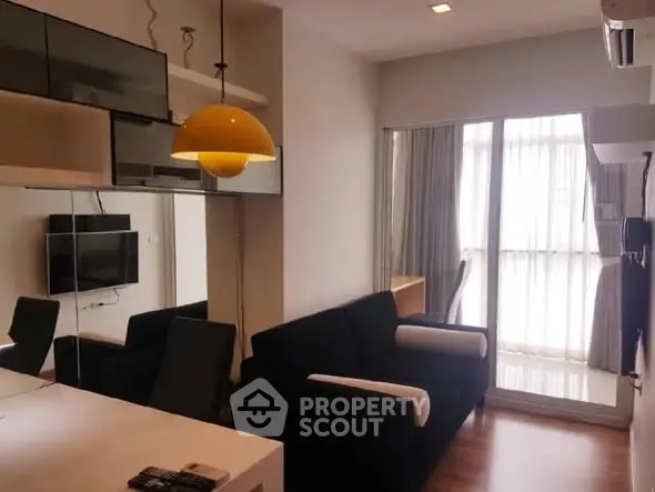 Modern living room with sleek furniture and large windows for natural light.